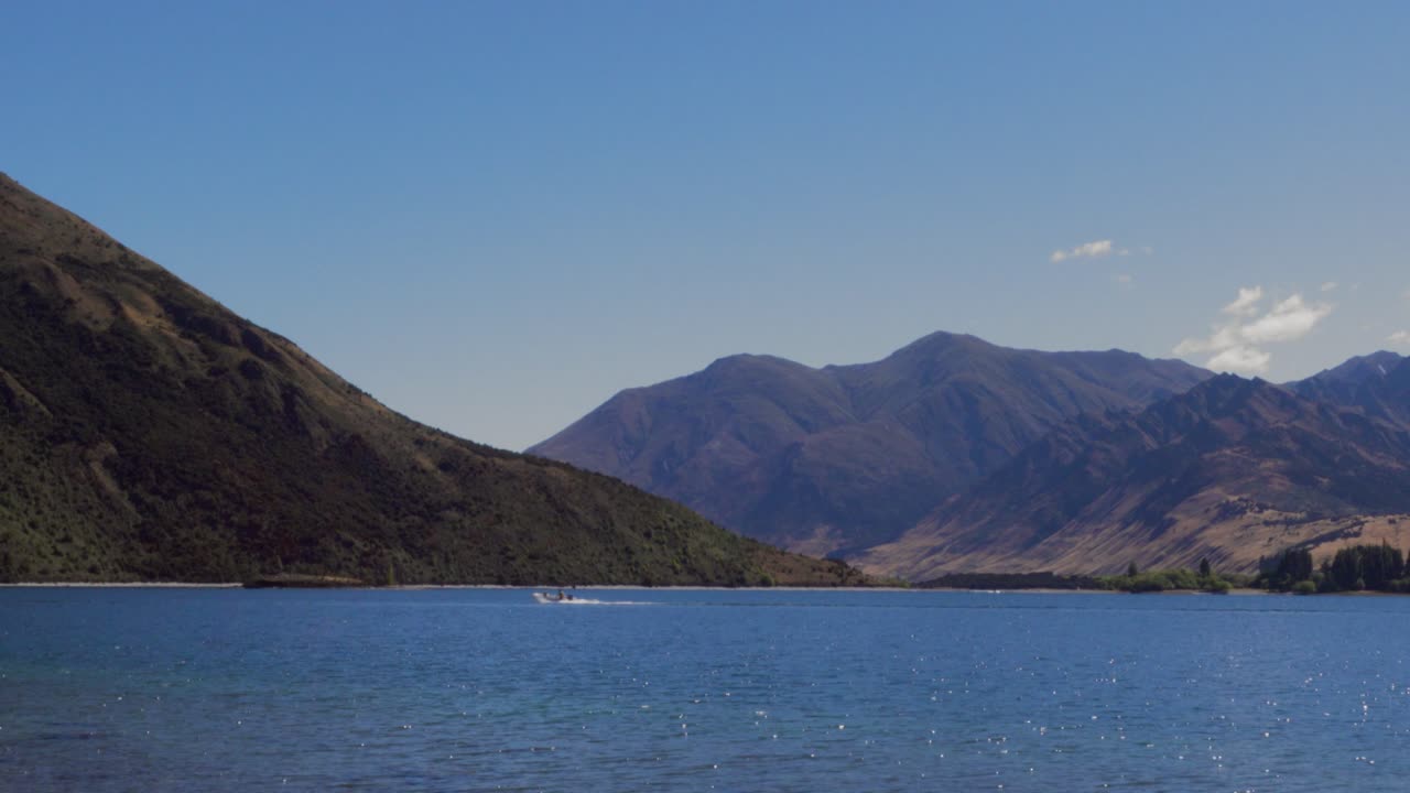 A Boat Soaring through Astounding Lake Wanaka, New Zealand