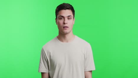 man pointing on green screen