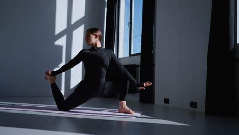 woman practicing yoga in a studio