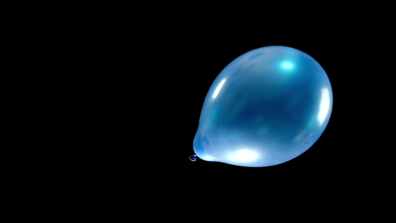 A single blue balloon gently falls down on the right side of the display. Perfect for use as a green screen element in various creative projects.