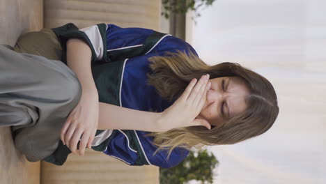 Vertical-video-of-The-sweating-young-woman-smells-bad-and-offensive.