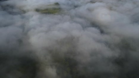 aerial drone over fluffy grey storm clouds to serene blue sky, 4k