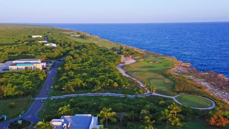 aerial sideways over seafront golf course of playa nueva romana in dominican republic