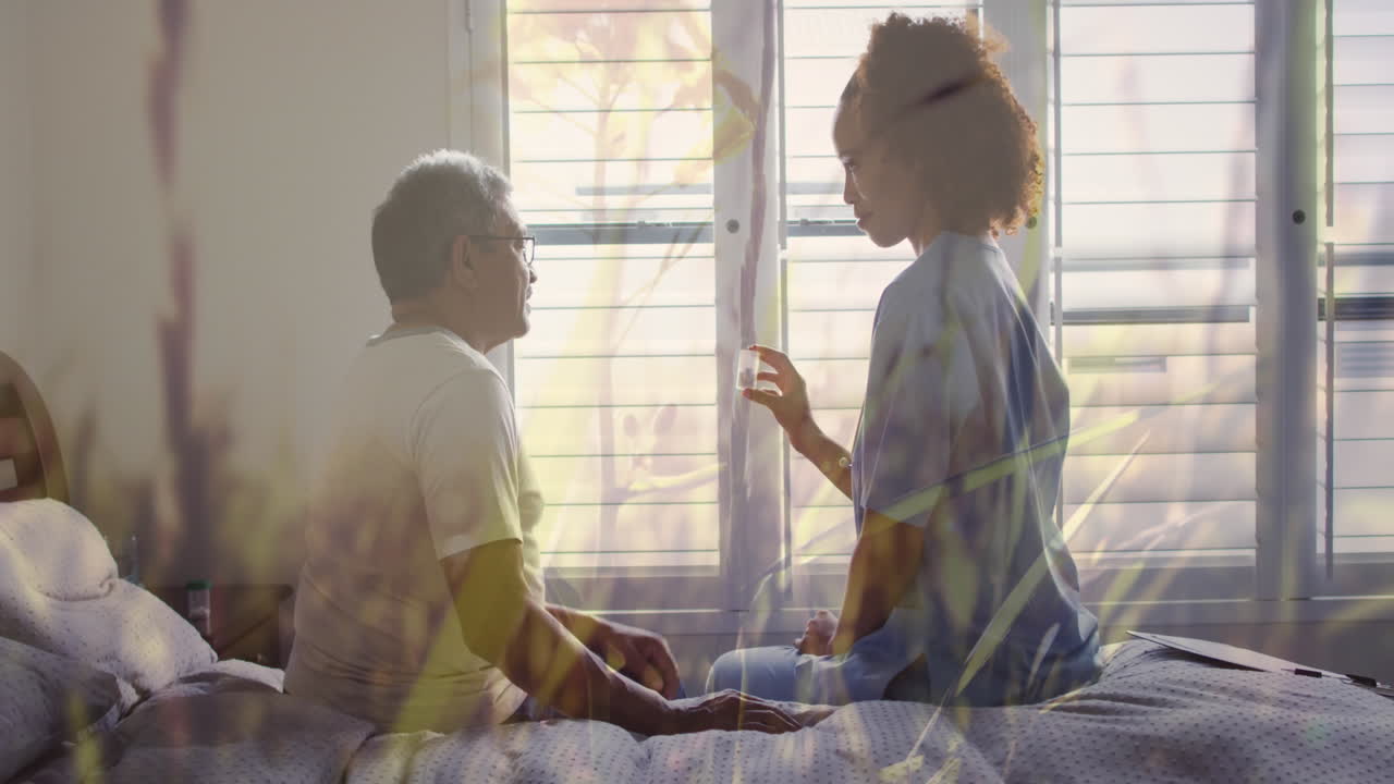 Animation of grass over diverse doctor and patient talking and holding medicine