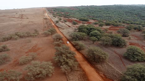 Aerial-over-cars-traveling-on-a-generic-rural-dirt-road-on-Molokai-Hawaii-from-Maunaloa-to-Hale-o-Lono-2