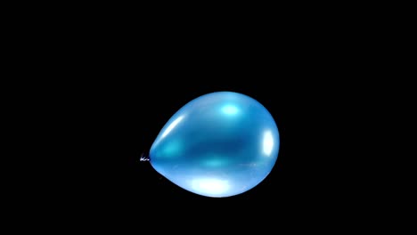 watch a shining blue balloon in the center of the frame in slow motion. this green screen clip allows easy background replacement, perfect for creating elegant event videos and party animations.