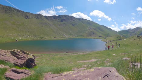 timelapse of a mountain lake in summer with some excursionists