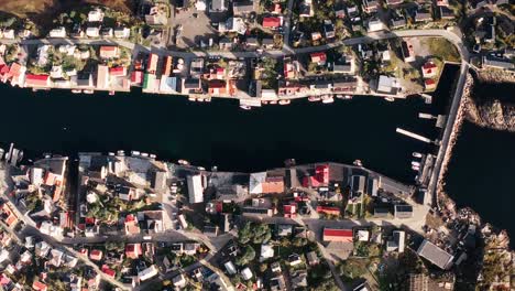 Top-down-Aerial-view-of-henningsvær,-beautiful-red-rorbu-and-fishing-boats,-in-the-Lofoten-Islands,-Norway