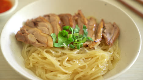 dried noodles with stewed duck in white bowl - asian food style