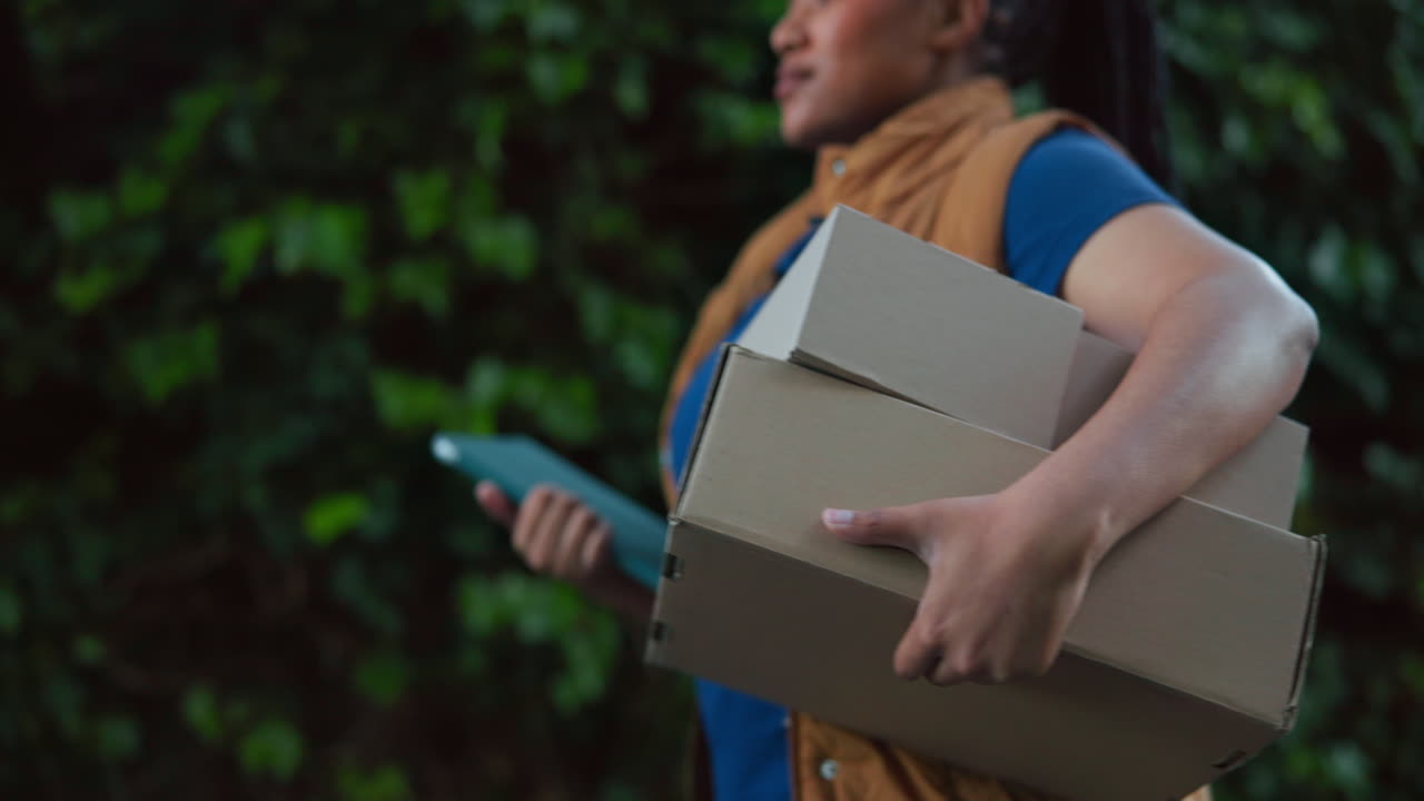 Delivery Woman Walking with Cardboard Boxes and Tablet Outdoors