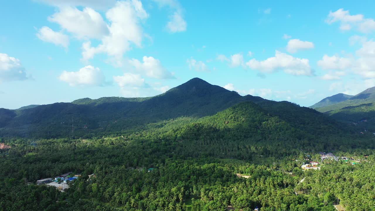 Aerial landscape with volcanic mountains on the horizon. Bright blue sky with fluffy clouds, Chiang mai, Thailand