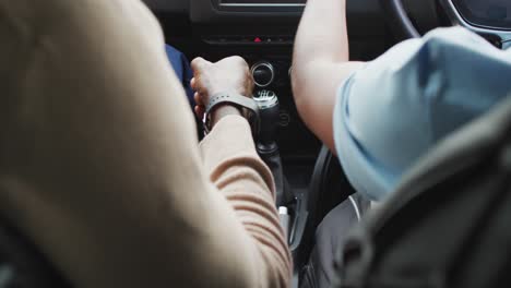 Video-of-hands-of-african-american-father-learning-son-how-to-drive-a-car