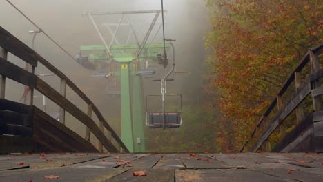 revealing shot of old rusty abandoned ski lift at resort in summer fog