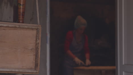 woman cook working in an old-style kitchen in chobareti meskhetian house mzianeti in georgia, preparing khinkali dumplings - selective focus