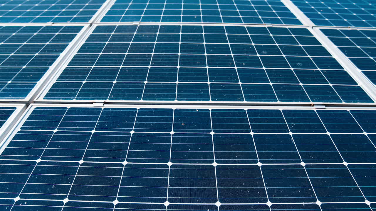 Electrical innovation. Blue photovoltaic panels. Sustainable source of clean energy getting from the sun. Modern sunny batteries. Close-up.