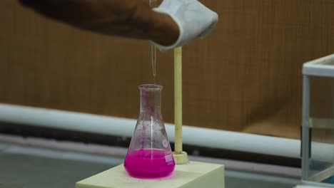 food quality control expert inspecting at milk specimen in the laboratory. selective focus