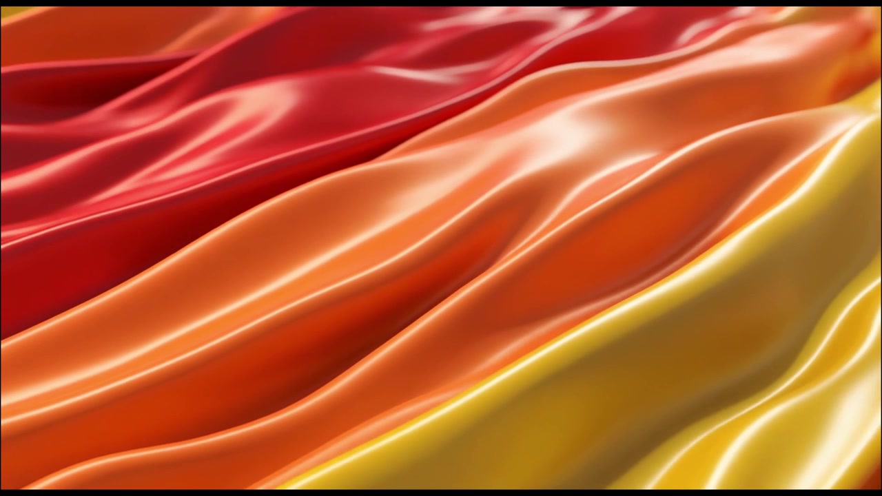 Abstract Background of Flowing Red, Orange, and Yellow Silk Fabric