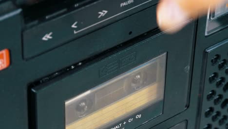 insert audio cassettes into the tape player and pushing play, stop buttons