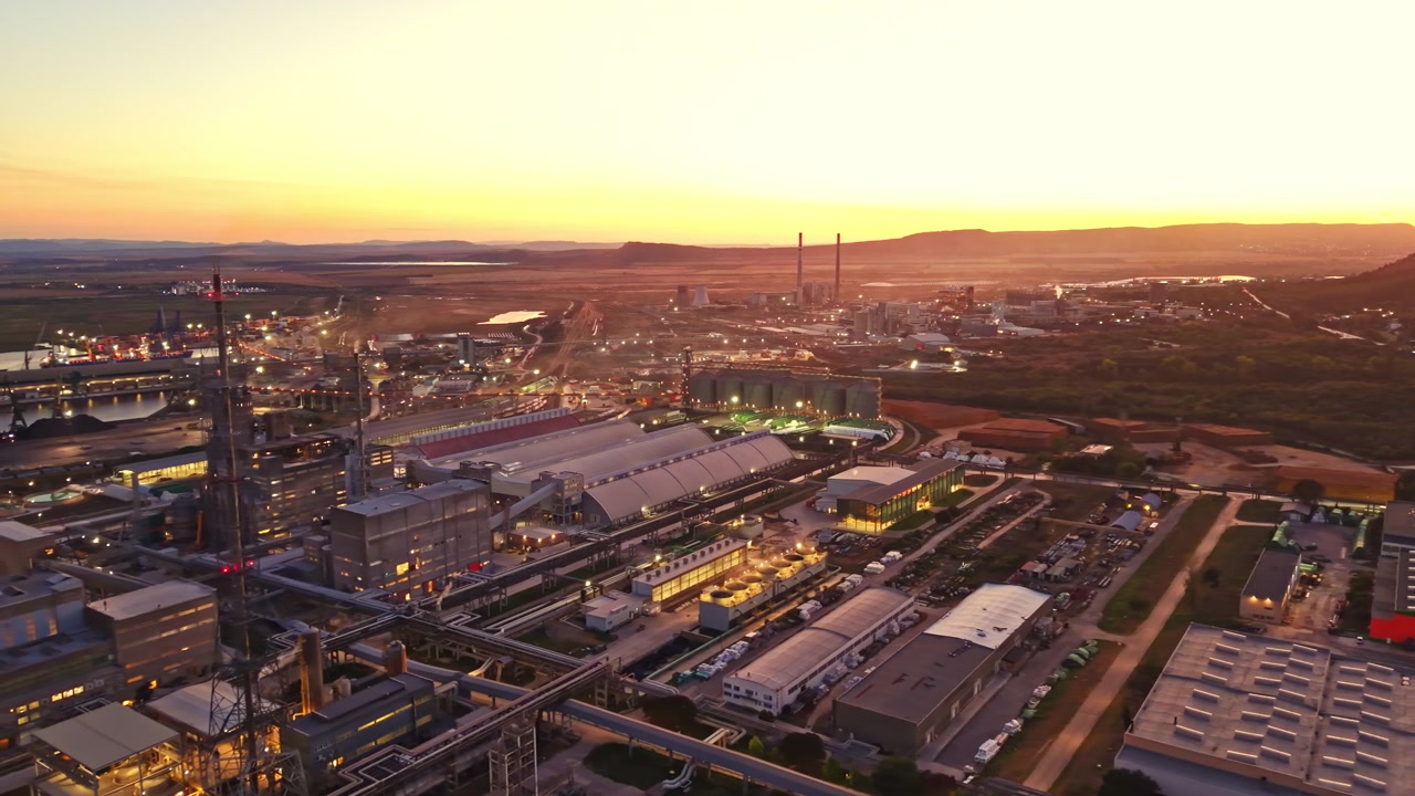 Sunset view over industrial area with factories and open fields in the background