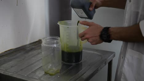 scientist preparing green sea weed fish food for aqua farming facility