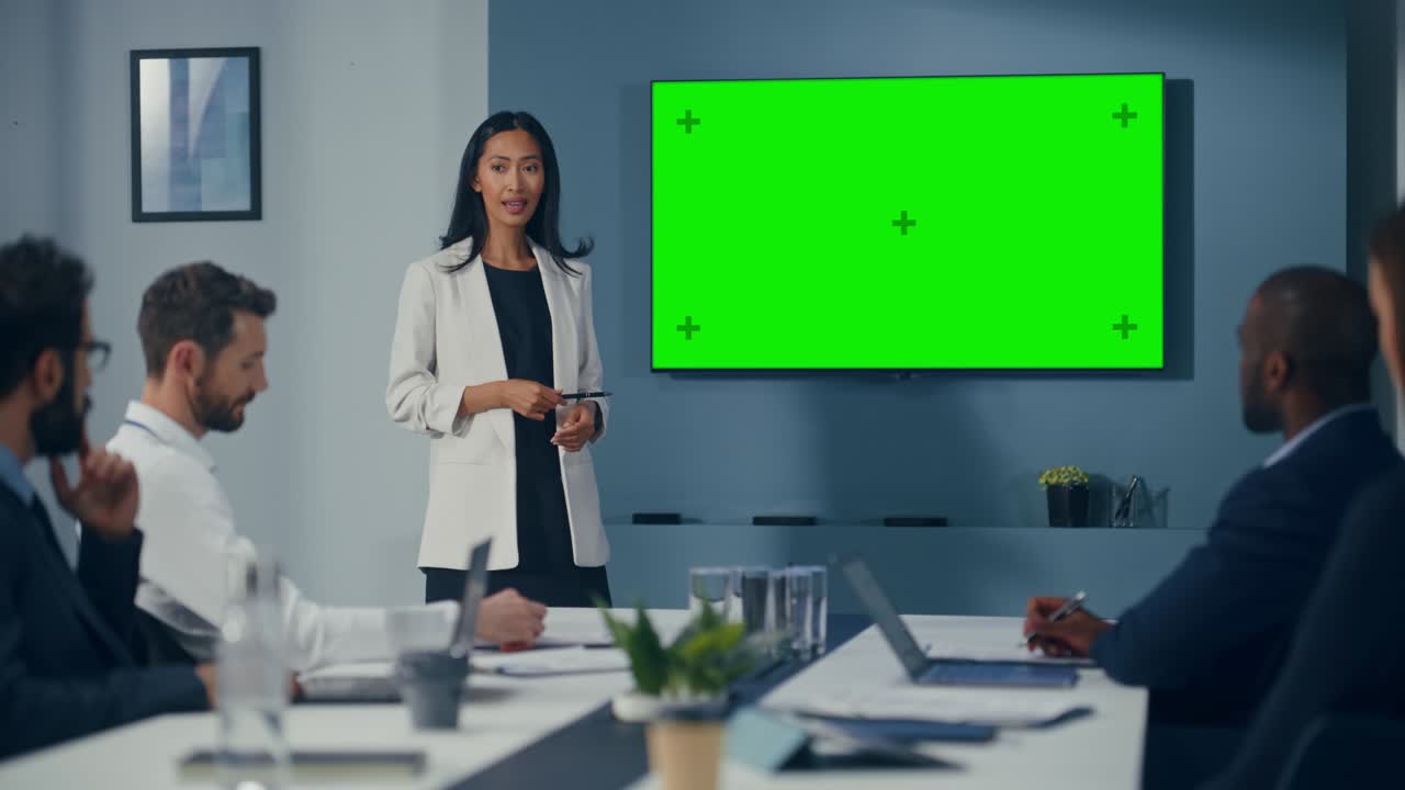 Office Conference Room Meeting Presentation: Motivated Female Digital Entrepreneur Talks, Uses Green Screen Chroma Key Wall TV. Successfully Presenting a Product to Group of Investors. Slow Motion