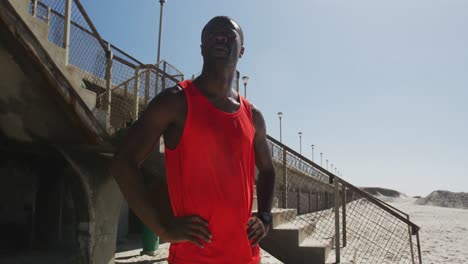 Focused-african-american-man-admiring-view,-taking-break-in-exercise-outdoors