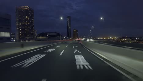 tokyo highway at night: new territories drive capture the allure of tokyo’s new territories from the car front view, with neon lights and cityscapes in the distance