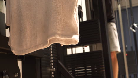 Towel-and-strong-guy-practising-in-gym,-Low-angle-front-view-shot