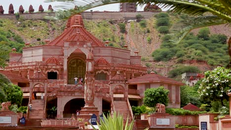 artistic-red-stone-jain-temple-at-morning-from-unique-angle-video-is-taken-at-Shri-Digamber-Jain-Gyanoday-Tirth-Kshetra,-Nareli-Jain-Mandir,-Ajmer,-Rajasthan,-India-an-Aug-19-2023.