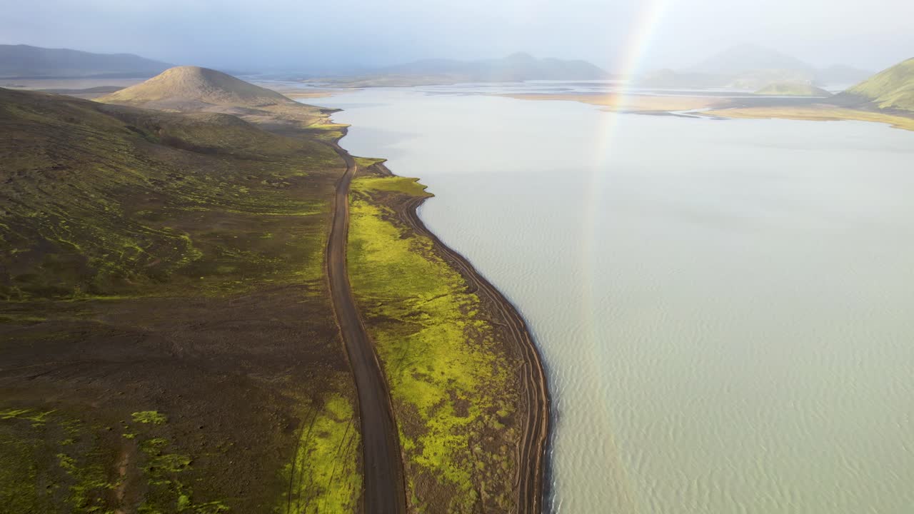 montañas verdes y un lago contra un cielo nublado
