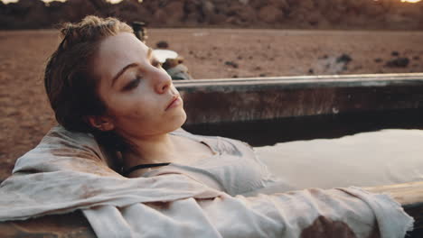 Woman-Taking-Bath-with-Dirty-Water-at-Dystopian-Campsite