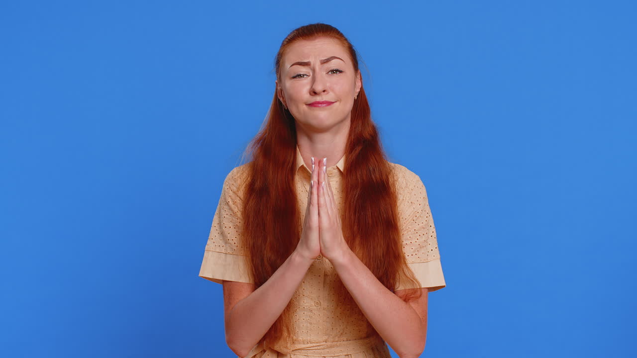 Attractive woman praying looking upward making wish begging apology asking help forgive me