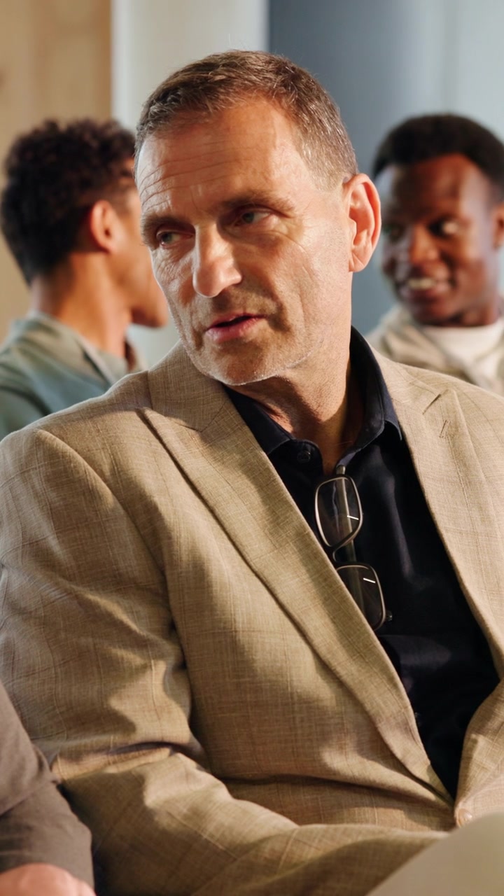Mature Businessman Talking During a Meeting in an Office