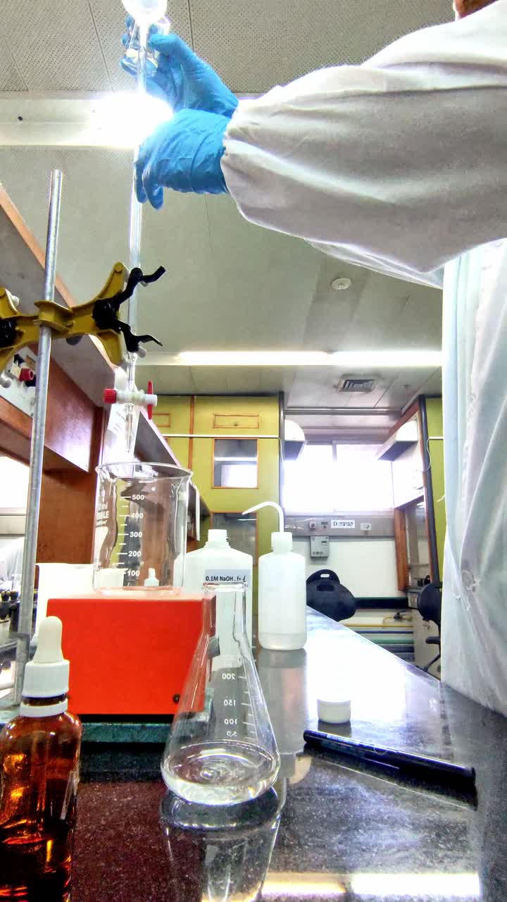 Chemist Wearing Gloves Handling Lab Equipment