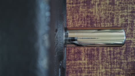 Top-down-shot-of-a-male-hand-quickly-putting-on-a-dumbbell-collar