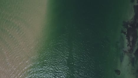 AERIAL-birds-eye-pov-of-water-and-boats