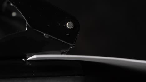 close up view of a perforator making holes in paper sheets