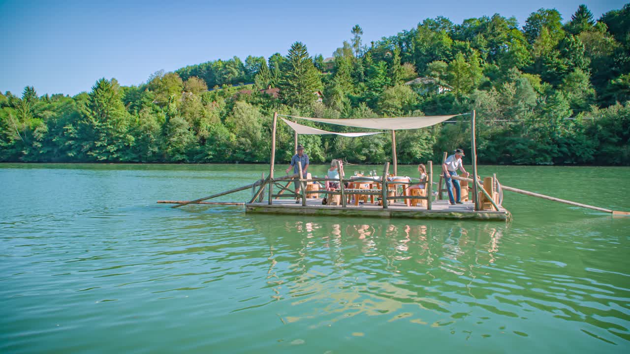 Slow motion shot of a traditional Slovenian raft navigating through Drava river