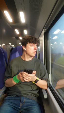 young man traveling by train