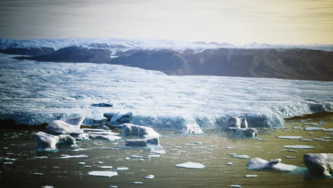 Glacier landscape reflecting sunlight on a calm water surface in the arctic