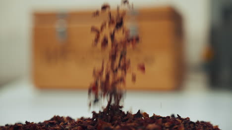 close up shot of a male hand picking up aromatic dried spice herbs from a table