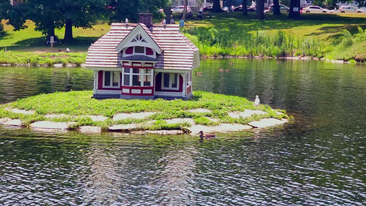 Miniature House on an Island in a Park Pond