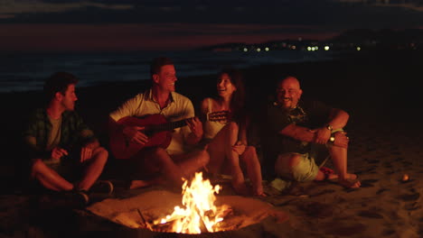 friends enjoying a night by the beach campfire