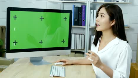 mujer asiática atractiva presente sobre su trabajo en la pantalla verde del pc. personas con concepto de comunicación.