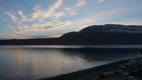 iceland arctic sea landscape with snow capped mountains in background, sunset, static