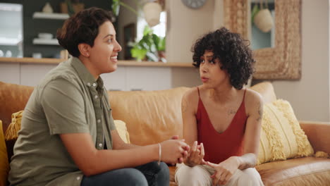 two women talking on a couch