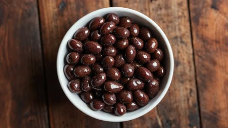 met chocolade bedekte noten in een witte schaal
