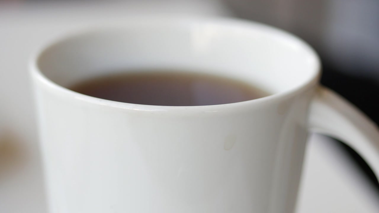 Steaming Hot Tea or Coffee in a White Ceramic Mug