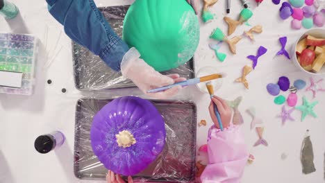 decorating art pumpkins with glitter