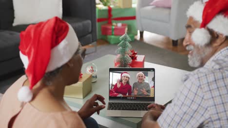 Happy-senior-african-american-couple-on-video-call-with-family-at-christmas-time